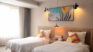 A hotel room with two beds, a nightstand, a lamp, and a painting on the wall. - Pai Hotel (Xinchang Wanda Plaza store) (Xinchang)