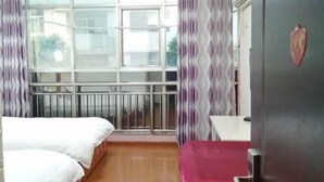 A hotel room with a large window, a bed, a bedside table, and a door with a heart-shaped decoration. - Grand Hyatt Sansui (Sansui)