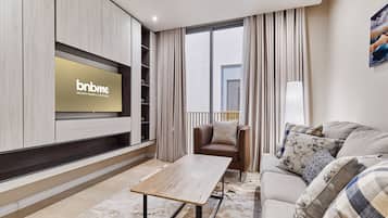 Business Apartment | Living area | 42-inch LCD TV with cable channels, Netflix, streaming services