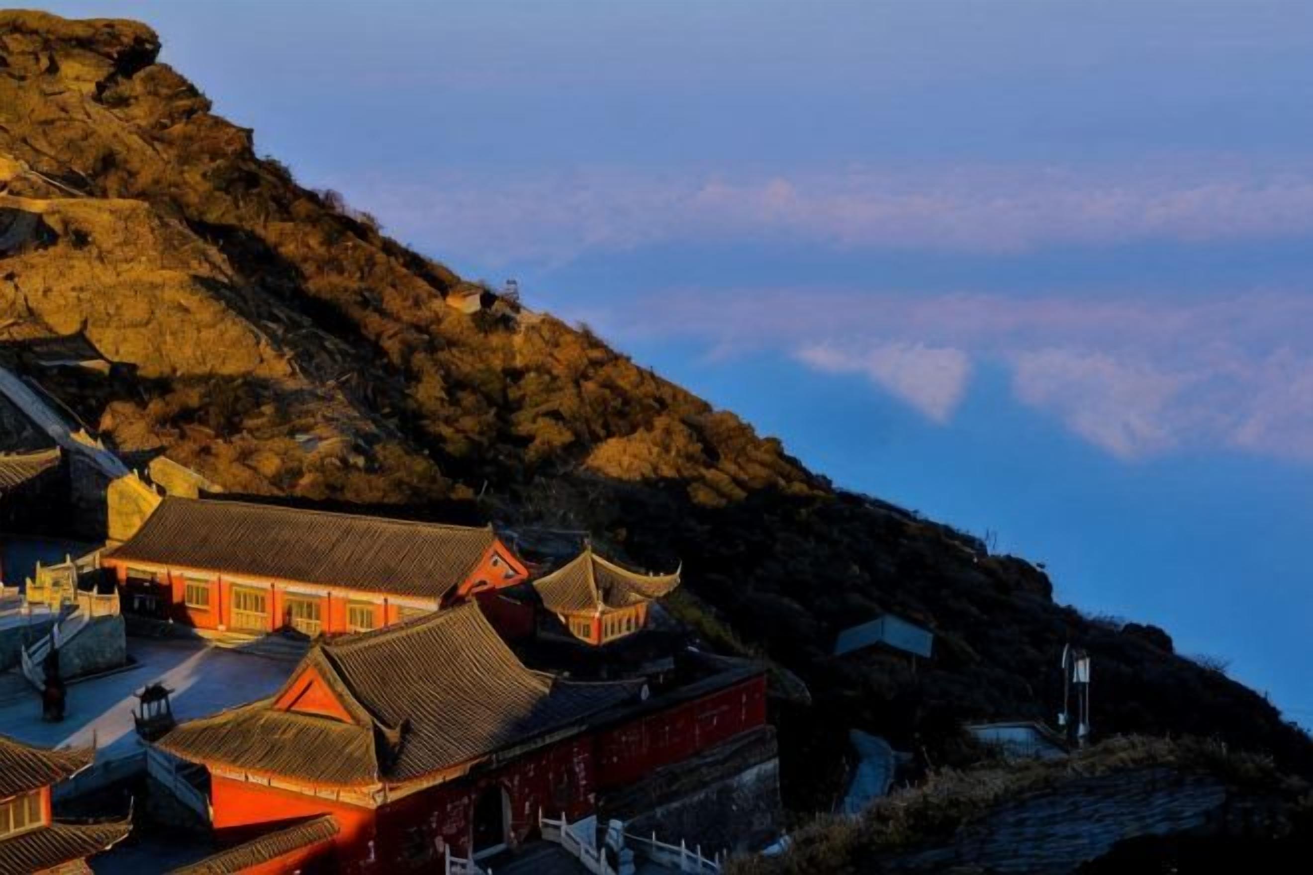 A traditional building with a steep roof, located on a hillside.