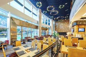 A modern restaurant with high ceilings, large windows, and a central seating area. - Fanhua Hotel (Quanzhou)