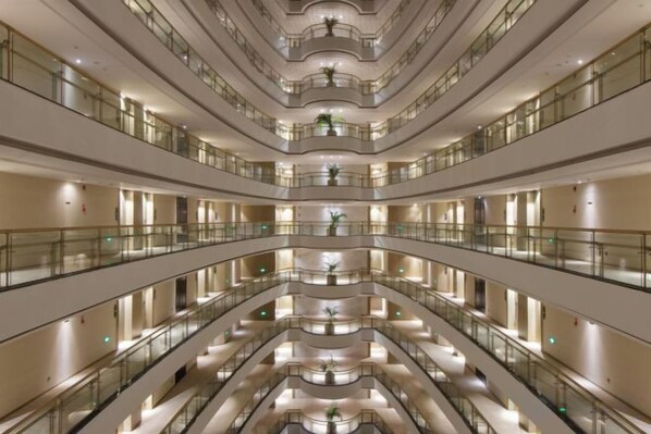 A multi-level atrium with balconies, reflective floors, and a central open space. - Fanhua Hotel (Quanzhou)