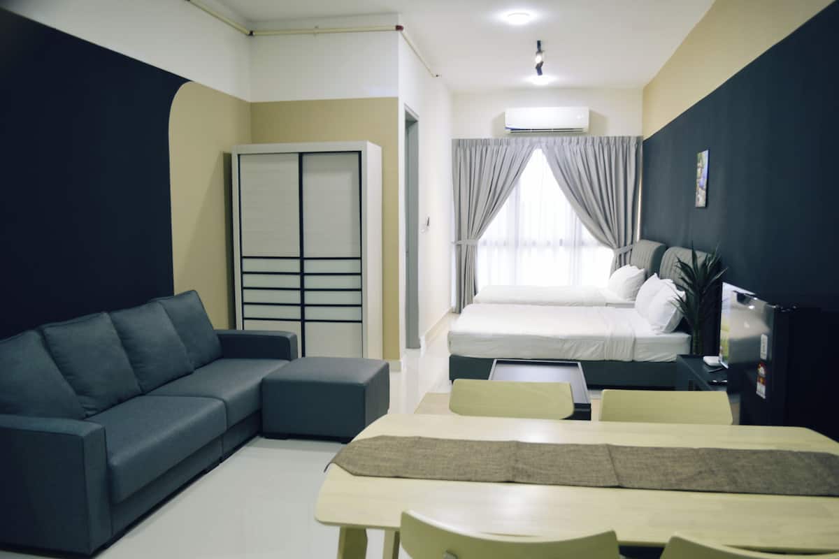 A modern hotel room with a sofa, a bed, a dining table, and a large window with curtains.