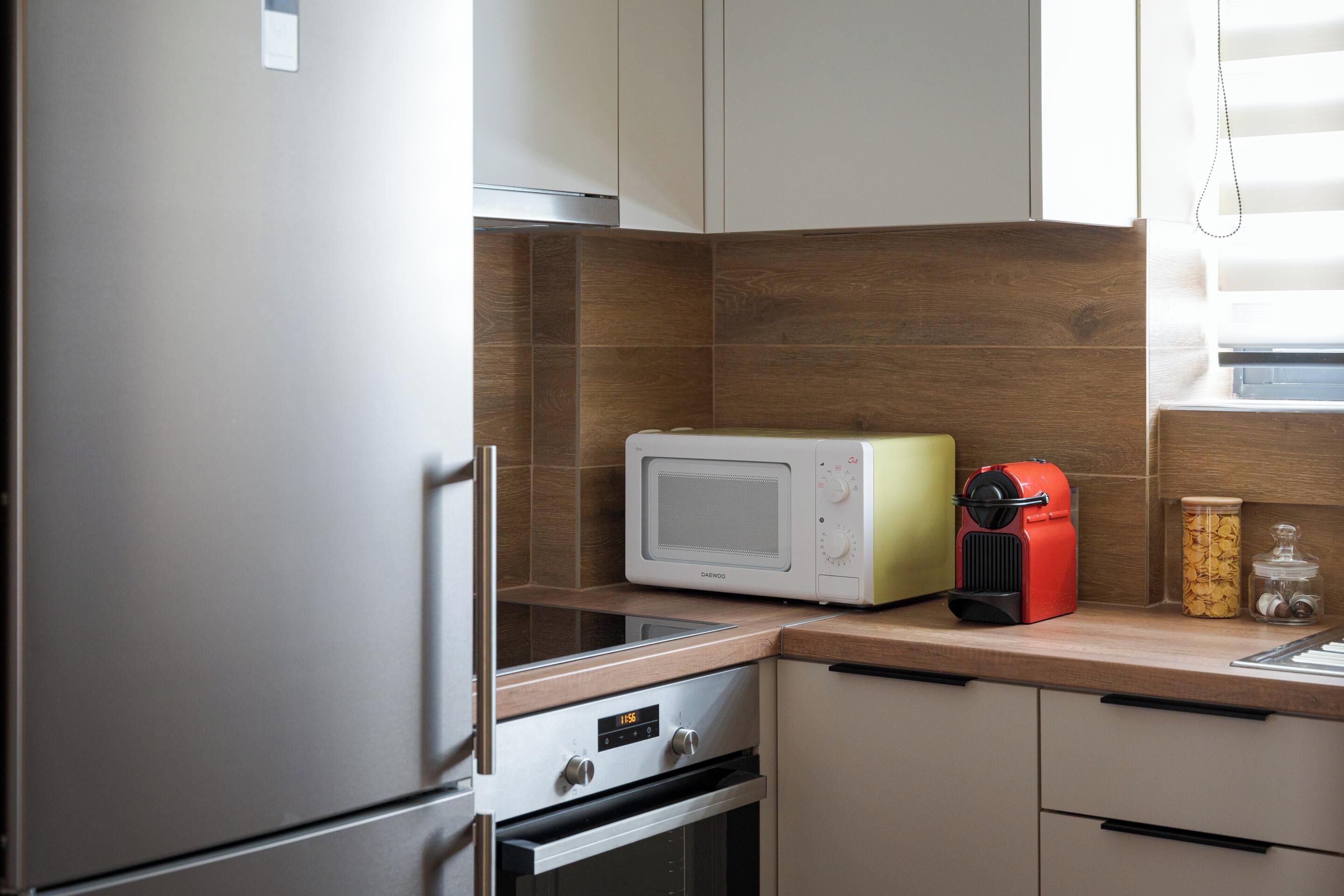 A compact kitchen with a microwave, toaster, and oven.