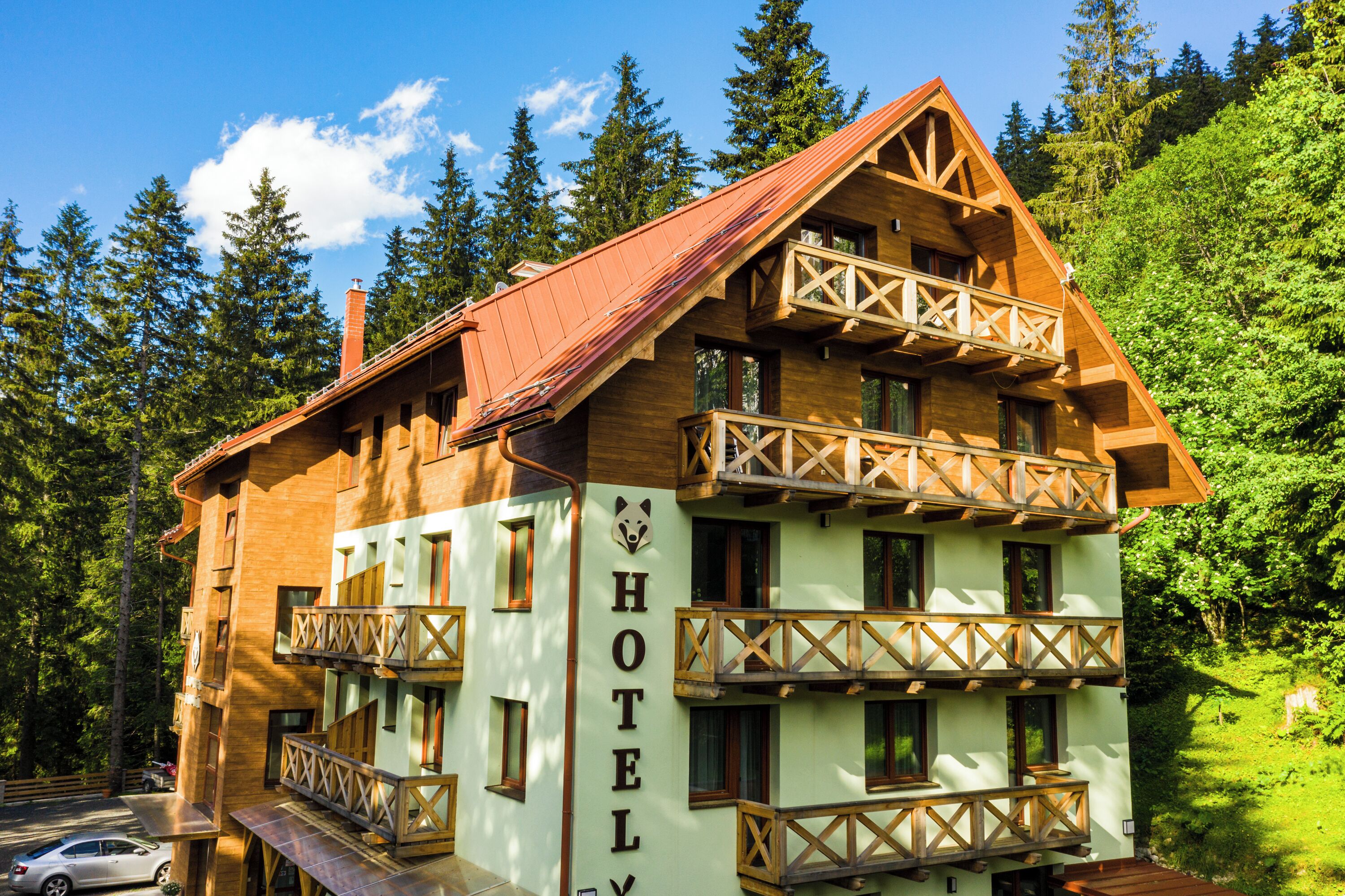 A multi-story wooden hotel with balconies and a sign reading "HOTEL".