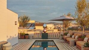 A rooftop pool area with a checkered floor, a central pool, and seating arrangements. -  Miiro Borneta (Barcelona)