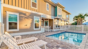 A two-story house with a swimming pool, outdoor seating, and a white picket fence. - Newly-Renovated Beach Home with Private Pool Quick Beach Access! Slps 16 (Panama City Beach)