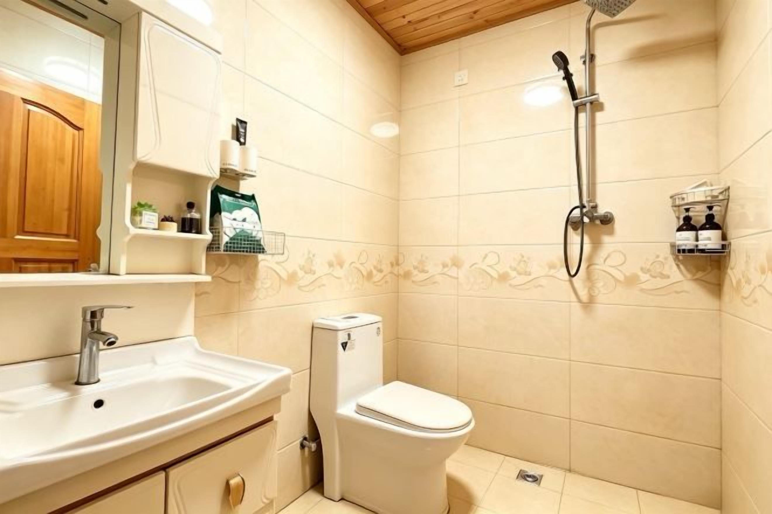 A bathroom with a sink, toilet, and shower.