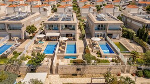 A residential area with modern buildings, rooftop solar panels, and swimming pools. - Villa Calla ZadarVillas (Petrcane)