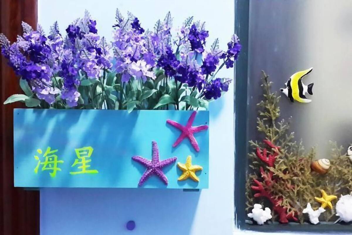 A decorative display with purple flowers and starfish.