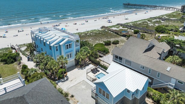A coastal property with a beach view, a pier, and a swimming pool. - Sip by the Pool - One bedroom, Pool, Beach Access (Pawleys Island)