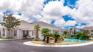 A residential area with houses, a swimming pool, and a landscaped garden.