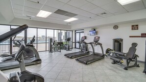 A gym with treadmills, elliptical machines, and weight equipment. - Waterfront Pool: Orange Beach Condo w/ Views! (Orange Beach)