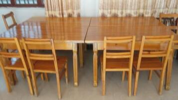 A rectangular dining table with six wooden chairs.