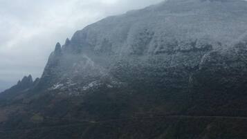 A mountain with a rugged terrain and a clear sky.