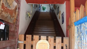 A wooden staircase with a plaque reading "SPOILED FISH" at the top.