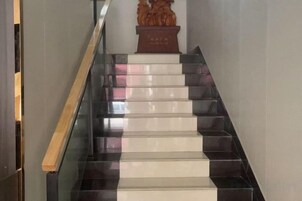 Una escalera con peldaños alternados en blanco y negro que conducen a una plataforma.