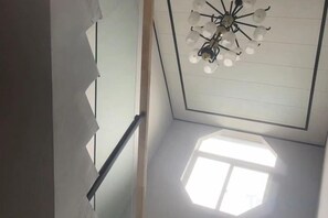 A staircase with a handrail and a ceiling light fixture. - Huainan Longmen Hotel (Huainan)