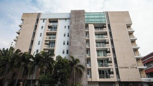 A multi-story Harmony Living building with a modern architectural design, featuring balconies and large windows. - 5C - 2 Bedroom Downtown Apartment With Shared Pool (Bangkok)