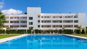A modern building with a swimming pool in front. - Faro's Angel Miraflores Penthouse (Mijas)
