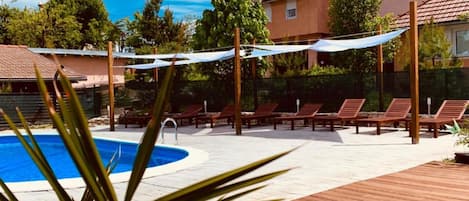 Seasonal outdoor pool, pool umbrellas, pool loungers