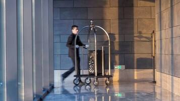 A modern elevator with a metallic cart and a glass container.