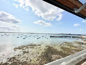 A coastal view with boats in the water and a rocky shoreline. - Pieds dans l'eau ! T2 Top Cosy – Vue mer 180° (Port-Louis)