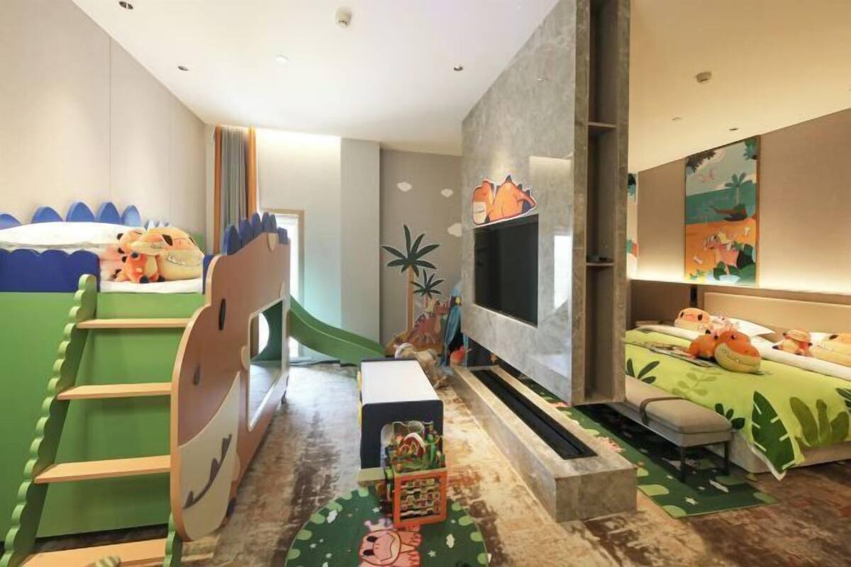 A children's room with bunk beds, a TV, and playful decor.