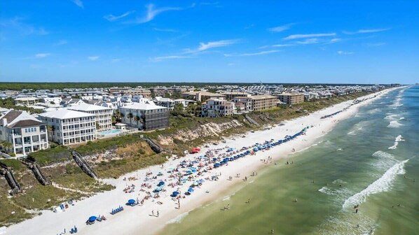 A coastal town with beachfront properties, a sandy beach, and ocean views.