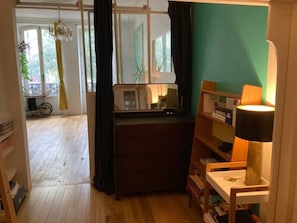 Guest room with a desk, bookshelf, and window.