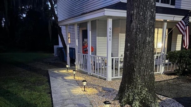 A residential house with a porch, a driveway, and a tree. - Cozy, Coastal Retreat! Minutes from Parris Island! (Port Royal)