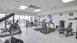 A gym with treadmills, elliptical machines, and weight equipment. - Newly Renovated Oceanfront Orange Beach Condo! (Orange Beach)
