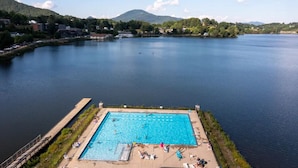 A swimming pool with a view of a lake and mountains in the background. - Biltmore discount tickets|close to Cataloochee ski (Waynesville)