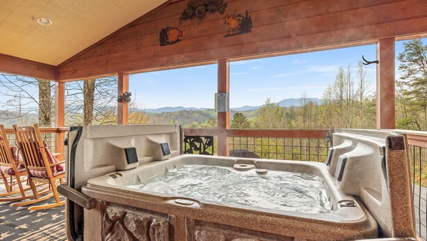 A hot tub with a view of mountains and trees. - Luxury Mountain View Cabin with Panoramic Smoky Mountain Views (SEVIERVILLE)