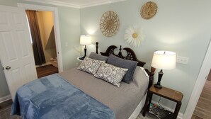 A bedroom with a bed, bedside tables, and a door leading to another room. - Spacious, Fully-Stocked, Walking distance to Downtown - With Comfy Mattresses! (Bardstown)