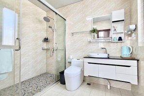 A modern bathroom with a glass shower enclosure, a white sink, and a marble-tiled floor. - Changzhou Lihua Xiaoyuan Inn (Changzhou)