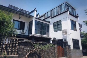 A modern two-story building with large windows and a traditional entrance gate. - Changzhou Lihua Xiaoyuan Inn (Changzhou)