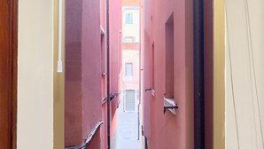 A narrow corridor with red walls and a door at the end. - Blue Eyes by Ca-sa Check (Chioggia)