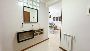 A modern bathroom with a large mirror, a vanity with star-shaped decorations, and a white radiator. - Hellen House by Ca-sa Check (Chioggia)