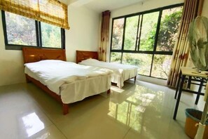 A room with two beds, large windows, a fan, and a trash bin. - Shennong Valley Xishui Hotel (Yanling)