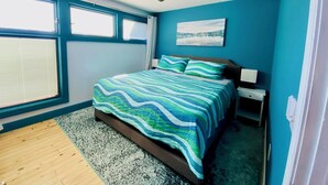 A bedroom with a bed, a ceiling fan, a window, and a painting on the wall. - Family friendly lakefront home with private boat ramp and dock (Summerton)