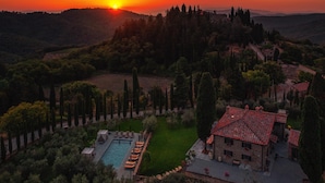 A villa with a swimming pool, surrounded by a well-maintained garden and tall cypress trees. - La Tuscia - Tenuta di Toscana Boutique Villa (Gaiole in Chianti)