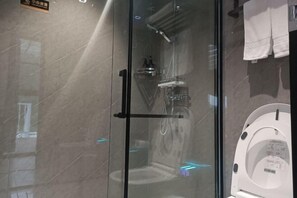 A glass-enclosed shower area with a white toilet visible through the glass. - Anqing Jushishan LOVE Homestay (Anqing)