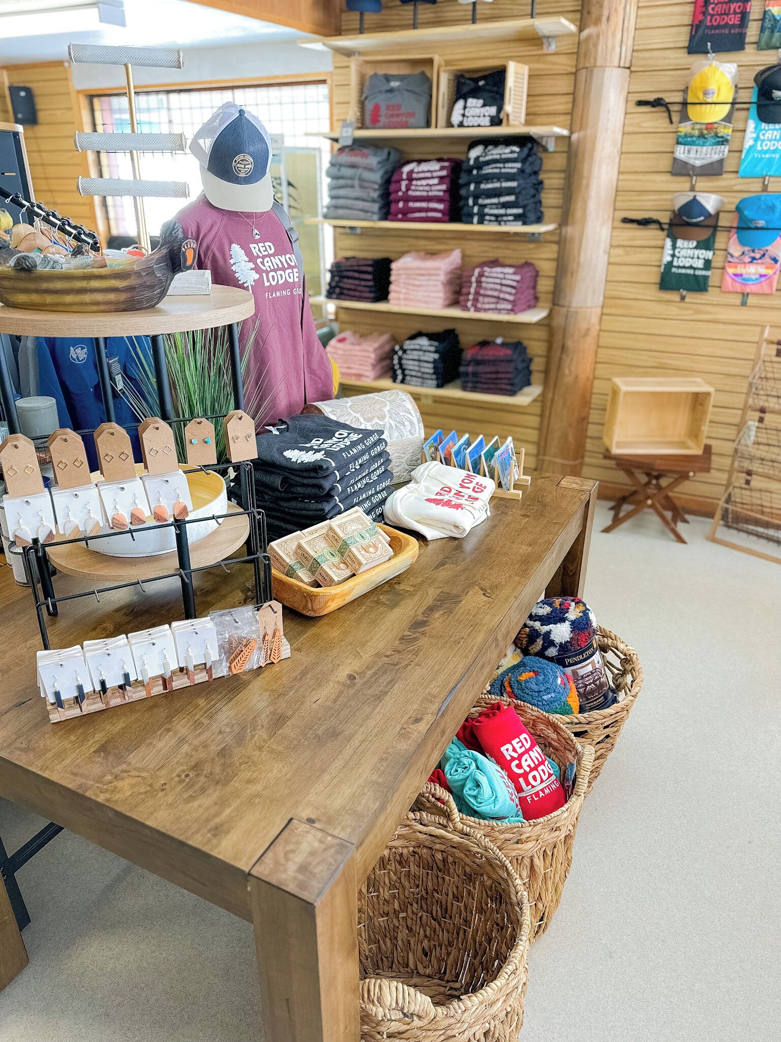 A retail display with various items including hats, t-shirts, and gift bags.