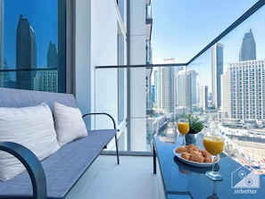 Enjoy a panoramic city view from the balcony with a seating area and cityscape views.