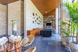 Relax in a serene space with a cabinet, circular mirrors, and a comfortable seating area.