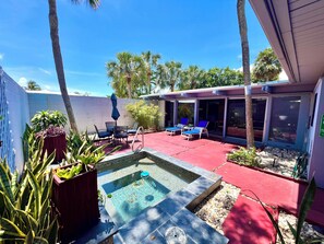 A backyard with a swimming pool, lounge chairs, and potted plants. - Chill Mid Century Beach Home 5 min Walk to Ocean. Fun Salt-Kissed Sanctuary! (Lauderdale-by-the-Sea)