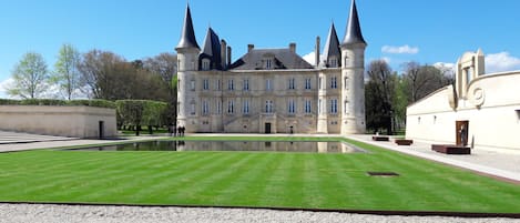 A large, historic building with multiple towers and a central courtyard.