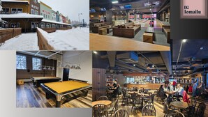 A billiards room with a pool table, a bar area with stools, and a seating area with tables and chairs. - Ameno 1, Himos by DG Lomailu - skiing, skiing, golf, padel and events (Jämsä)