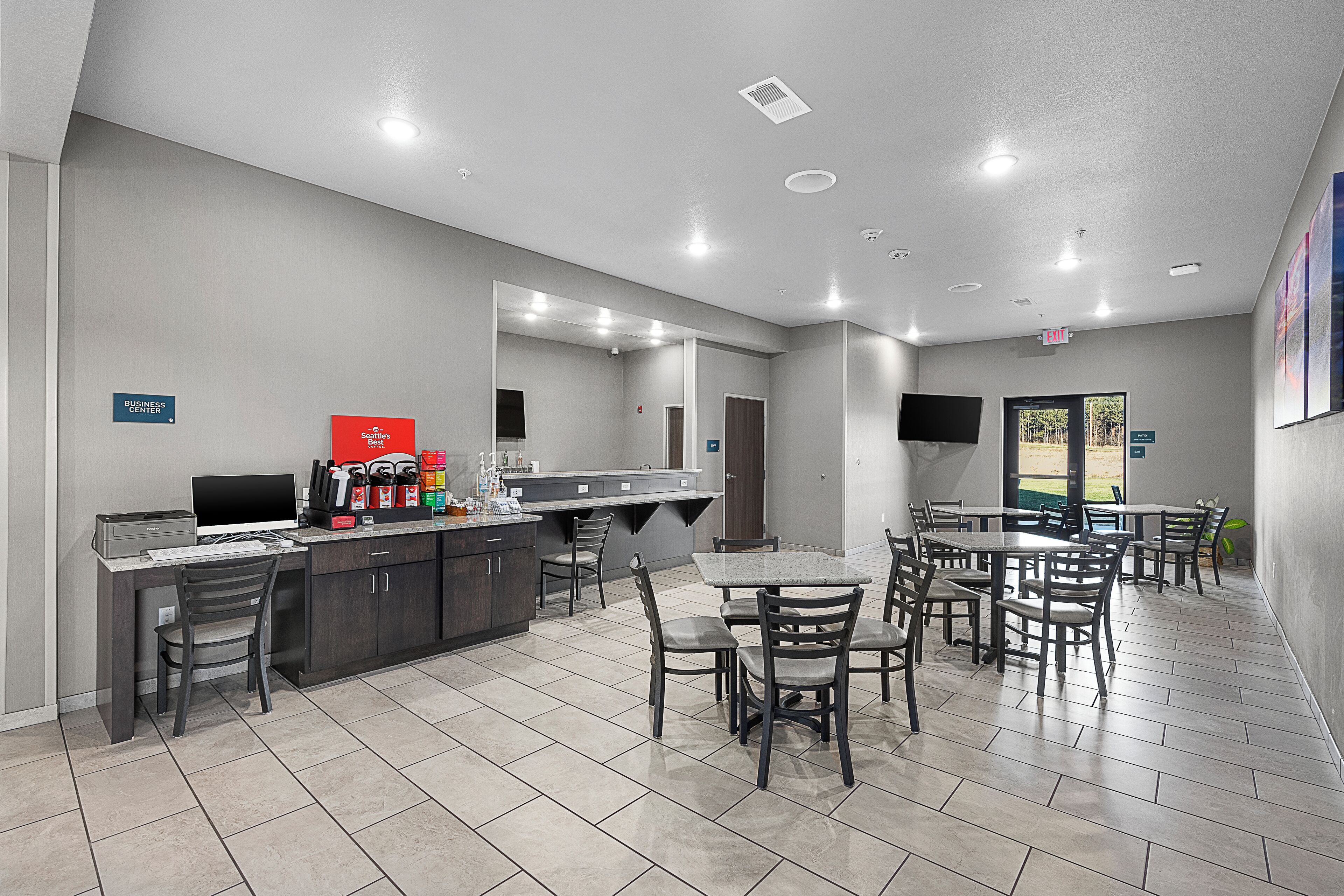 A modern dining area with a counter, chairs, and a television.